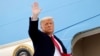 FILE PHOTO: U.S. President Donald Trump salutes as he boards Air Force One at after visiting the U.S.-Mexico border wall, in Harlingen, Texas, U.S., January 12, 2021