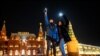 RUSSIA -- Young people turn on the flashlights of their mobile phones in support of jailed opposition politician Alexei Navalny near Red Square in Moscow on February 14, 2021.