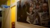 RUSSIA -- A painting depicting Russian President Vladimir Putin and the country's top political figures and officials with Novaya Gazeta newspapers hangs on the wall at the independent media outlet's editorial office in Moscow, March 24, 2021