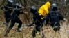 BELARUS -- Riot police detain an opposition supporter during a rally in central Minsk, November 22, 2020